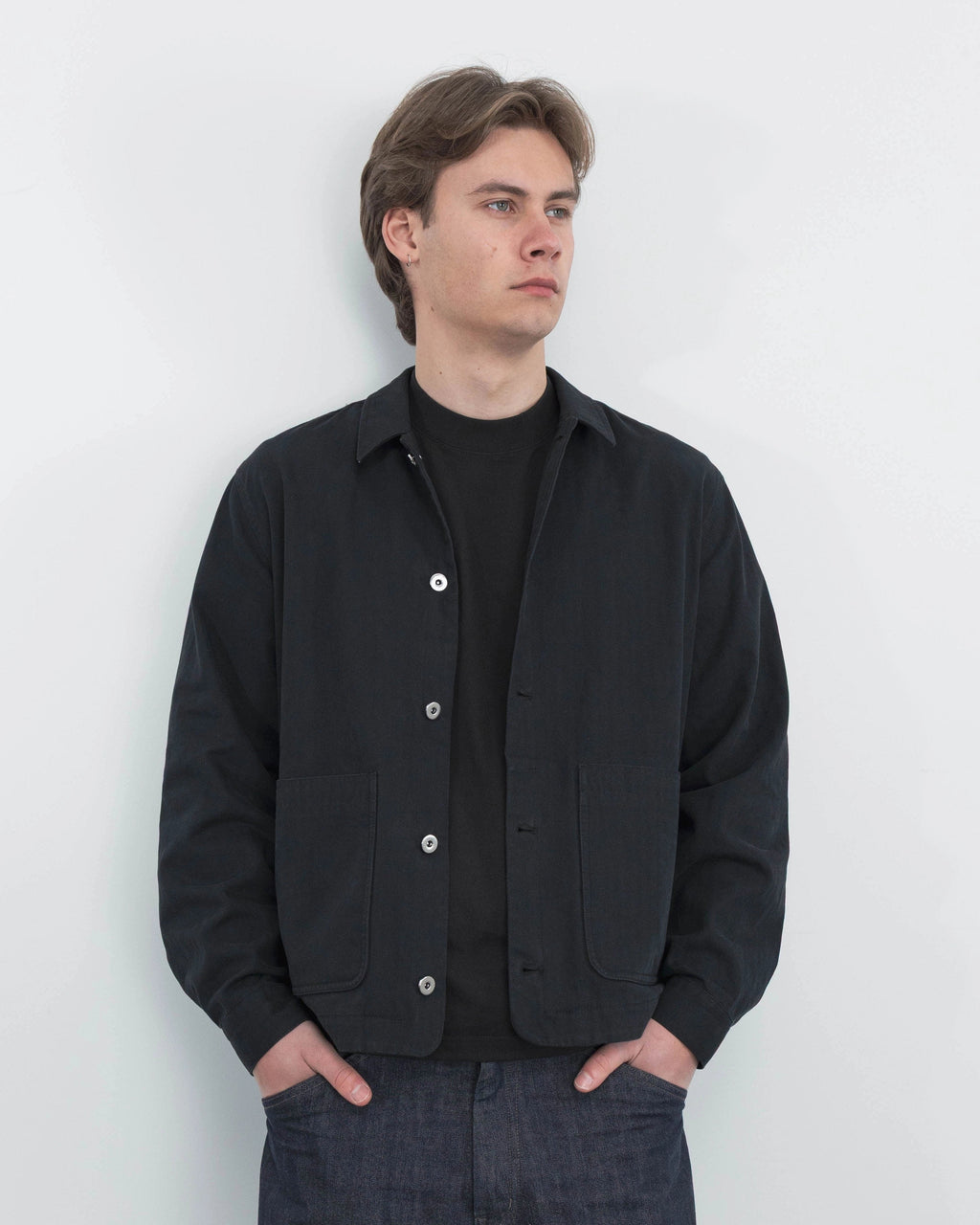 Model wearing Anderson black chore coat, campaign shoot
