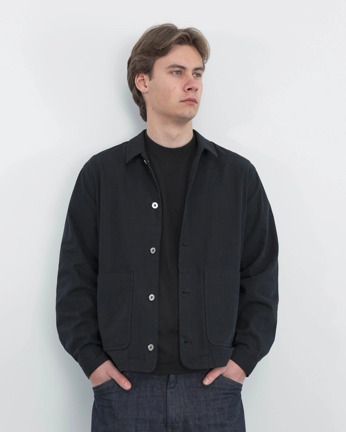 Model wearing Anderson black chore coat, campaign shoot