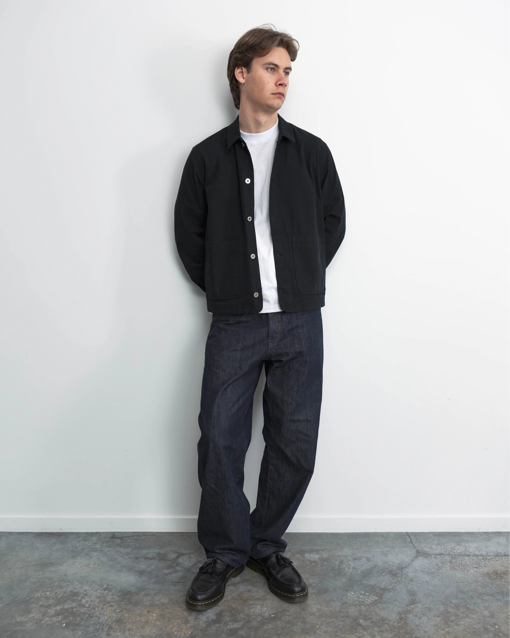 Model wearing Anderson black chore coat, campaign shoot