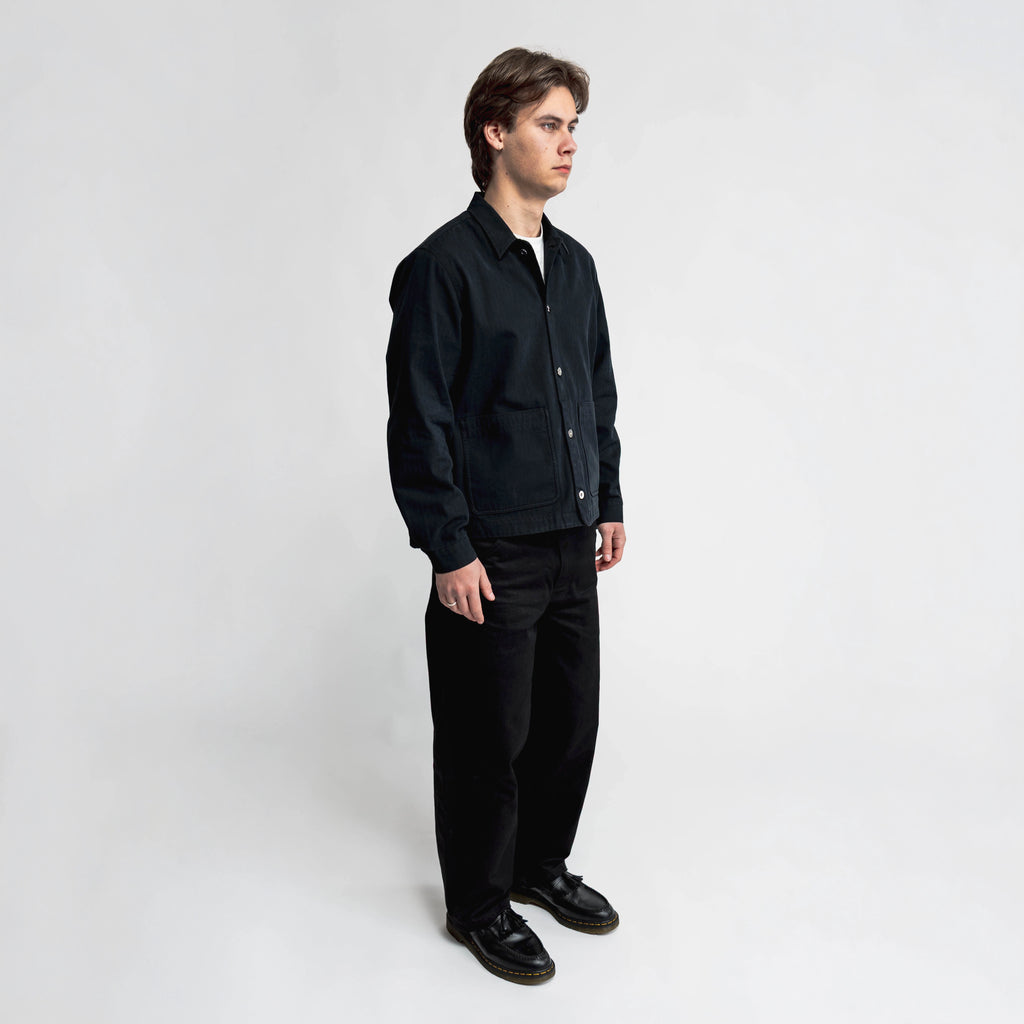 Anderson black chore jacket, side view showing double-entry pocket