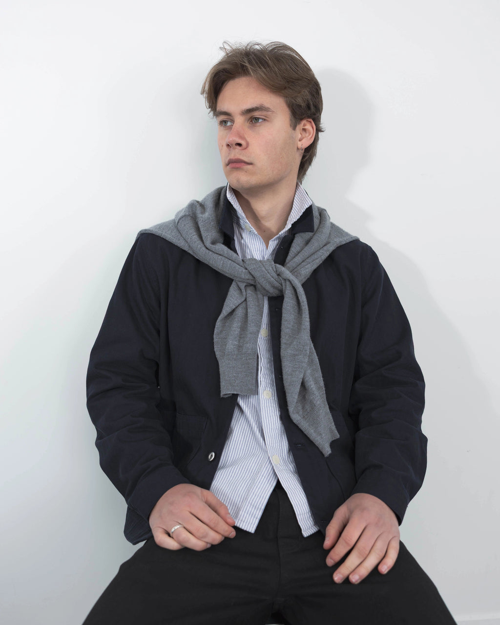 Model wearing Anderson navy chore jacket over white relaxed t-shirt