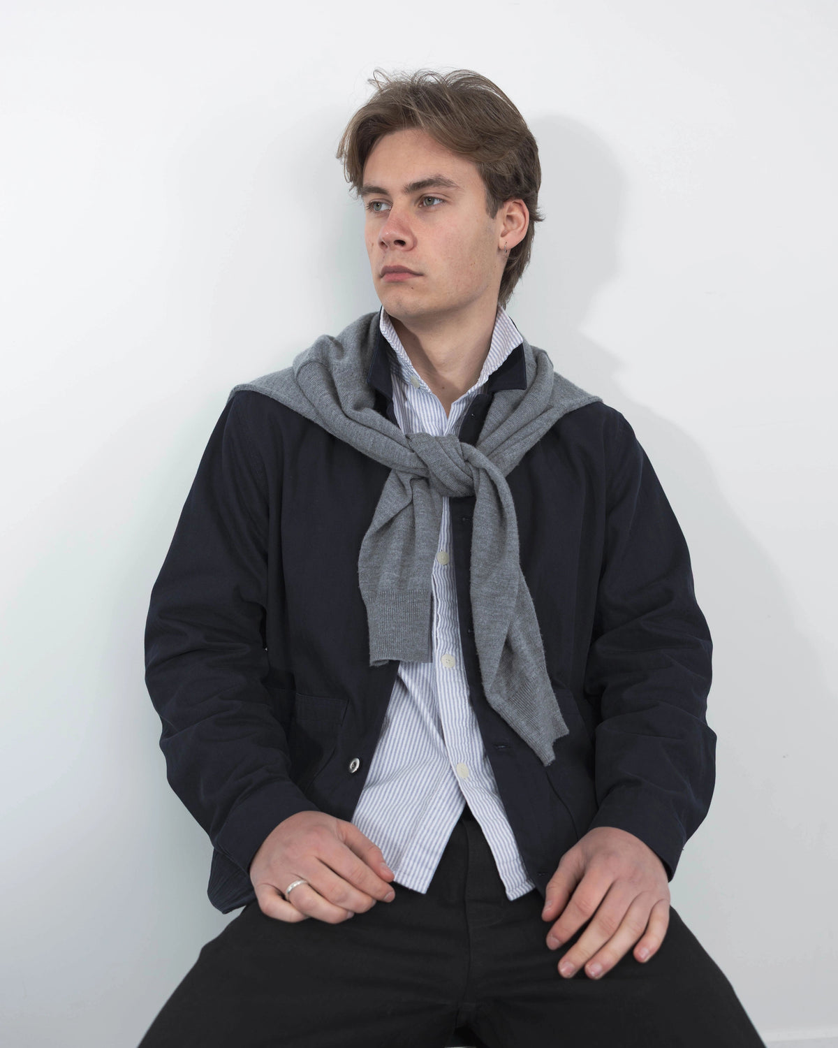 Model wearing Anderson navy chore jacket over white relaxed t-shirt