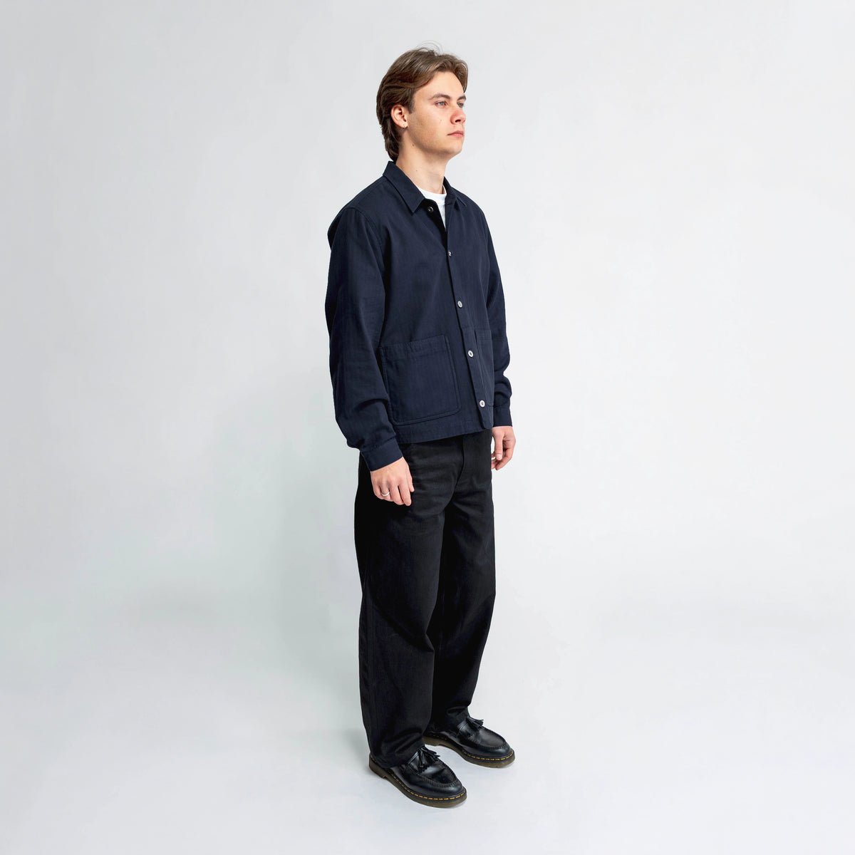 Anderson navy chore jacket, side view showing double-entry pocket